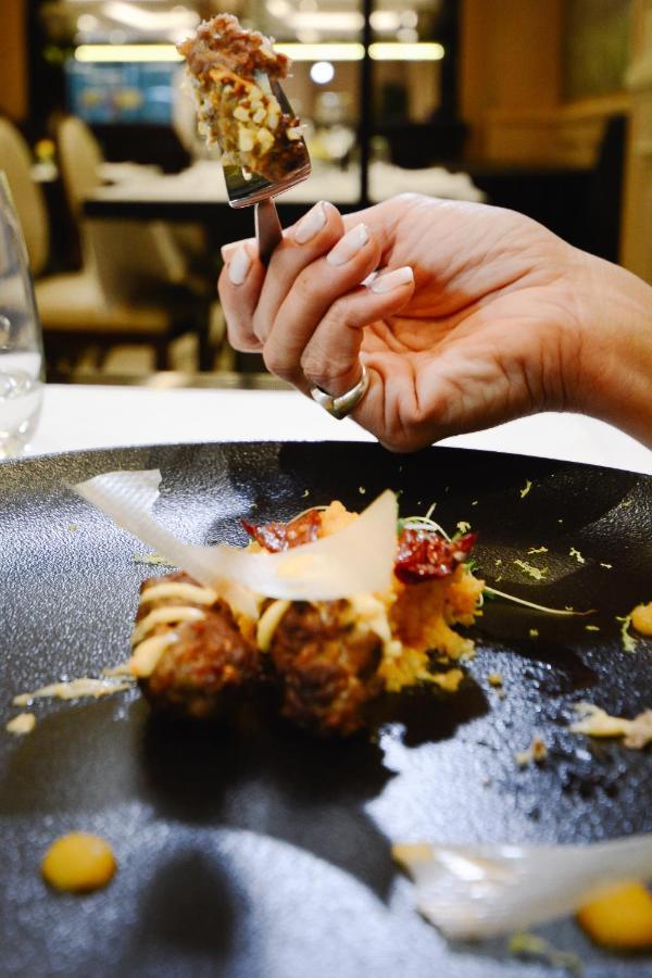 Diplomatichotel Mendoza Zewnętrze zdjęcie Parmigiano-Reggiano being grated over a dish